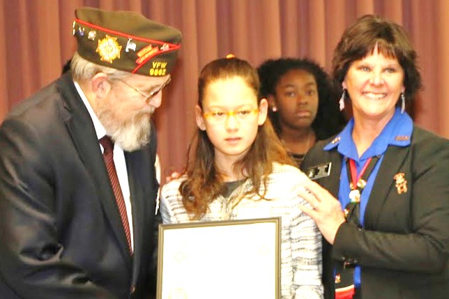State Commander and President awarding citation to young lady for her efforts.